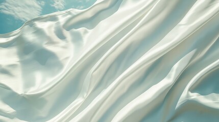 Poster - A beautifully flowing white fabric dances gracefully in the wind under a bright blue sky, conveying a sense of freedom, elegance, and artistic expression.