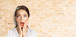 © vgstudio - Wow! Excited surprise, expressive happy black hair woman in white shirt. Funny girl with wide open eyes, mouth, hands on cheeks. Shop sales, discounts - ad concept banner image. Bricks wall background
