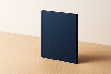 Poster - Minimalist standing dark blue book mockup on light wooden desk with soft beige background for branding or design presentation purposes.