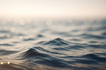 Poster - Peaceful ocean water surface with gentle waves and soft sunlight bokeh in tranquil natural seascape background concept at sunrise or sunset.