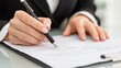 © affa_dreams - Professional Woman Signing Document with Pen on Table, Emphasizing Business Agreement and Contract, Office Environment for Corporate Setting Photography