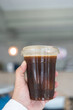 © Dontree - Iced black coffee, also known as iced Americano on hand