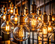 © Mahbub - Warm backlit glass bulbs with brass sockets in moody ambience