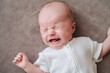© ADDICTIVE STOCK - Newborn baby crying on soft blanket
