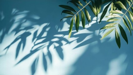 Poster - A shadow of a palm leaf on a bright blue wall, perfect for decorating and design