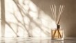 © svastix - An elegantly arranged reed diffuser bottle resting on a surface, casting soft shadows; it emphasizes tranquility and the beauty of enhancing one’s living environment.