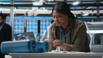 Poster - black engineering expert checking data on papers at the solar energy factory, conducting evaluations