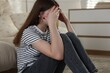 © New Africa - Depressed teenage girl on floor at home