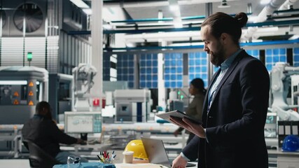 Poster - industrial male expert in suit inspecting solar power equipment, demonstrating efficiency in quality