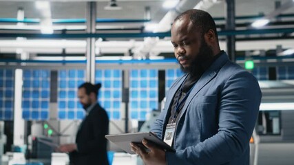 Poster - black master engineer overseeing photovoltaics production line in a factory, ensuring a successful m