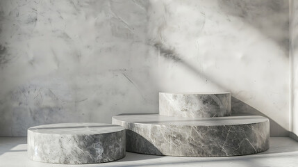 Poster - Three round marble podiums of varying heights are arranged in a studio setting against a textured wall with natural light creating shadows