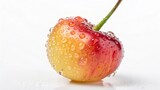 Single Rainier Cherry with Stem and Water Droplets on a White Background