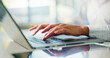 © peopleimages.com - Hands, typing and laptop at office for review, proposal and report for finance at corporate agency. Person, computer and click at job for revenue, audit and project management at insurance company