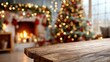 © Yulia - Rustic wooden table with Christmas tree and glowing fireplace in cozy holiday decorated living room, festive blurred bokeh lights creating warm winter atmosphere, Selective Focus