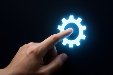 Poster - Activating the System: A finger delicately touches a glowing gear icon, symbolizing the activation of a system, the initiation of a process, or the start of a project.