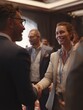 © Johannes - Business professionals meet for the first time at a conference, exchanging smiles and handshakes as they introduce themselves. The environment is welcoming and conducive to networking.