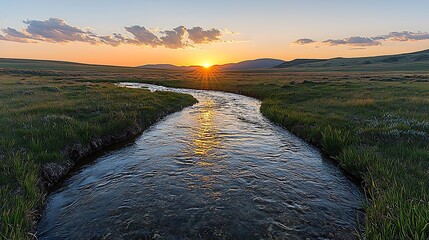 Wall Mural - Panoramic View of a Stream Flowing Through a Serene Landscape at Sunset