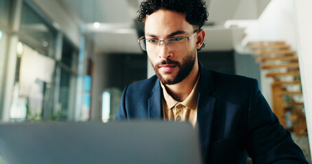 Poster - Serious, employee and man with laptop, office or reading financial report on website or bookkeeping. Business, accountant and person with tech for investment, research and review of account info