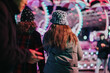 © qunica.com - Friends spends a joyful evening outdoors, enjoying the vibrant seasonal lights. The ambiance conveys warmth, companionship, and the joyous feelings of winter festivities amidst unique attractions.