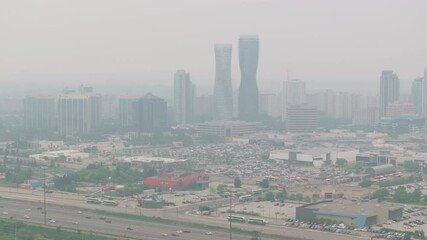 Wall Mural - mississauga skyline shrouded in wildfire smoke, creating a hazy atmosphere over the city