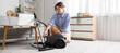 © Pixel-Shot - Young woman with vacuum cleaner in living room