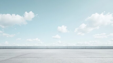 Wall Mural - A vast, empty concrete surface under a bright blue sky filled with scattered white clouds.