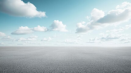 Wall Mural - Vast open landscape with a textured ground under a bright blue sky filled with scattered fluffy white clouds.