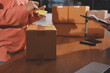 © Phanphen - Startup SME small business entrepreneur of freelance Asian woman wearing apron using laptop and box to receive and review orders online to prepare to pack sell to customers, online sme business ideas.