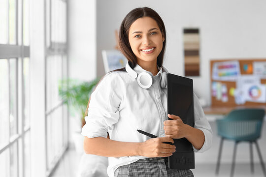 Female interior designer with graphic tablet in office