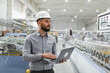 © Serhii - Industrial engineer working on laptop in modern factory