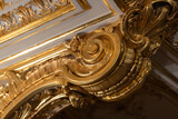 Detailed close-up of intricate gilded stucco moldings and wooden carvings
