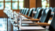 © Keo - A conference room with rows of empty chairs and a water bottle on a table in the foreground.