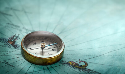 Poster - Magnetic old compass on old map. Travel, geography, history, navigation, tourism and exploration concept background. Retro compass on geography map.