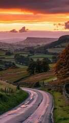 Poster - A winding road in the countryside at sunset with green trees and hills
