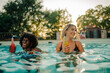 © Zamrznuti tonovi - Two smiling women relaxing and drinking refreshing beverages in swimming pool
