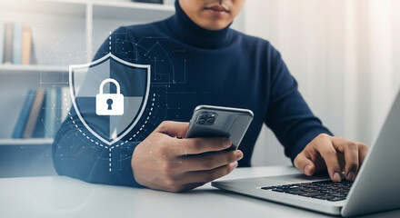 Poster - Person in turtleneck using laptop and holding phone with digital security shield overlayed on image