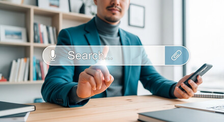 Poster - Man in blazer using search bar interface on screen with phone in hand at desk in front of bookshelf