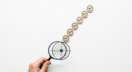 Poster - Hand holding magnifying glass over target with check mark icons in a diagonal line on white surface