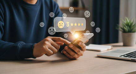 Poster - Person using smartphone to give a three star rating with sad face feedback online at the desk