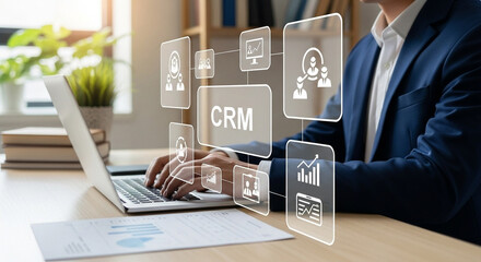 Poster - Businessman using laptop with crm interface and data analytics icons overlaying the screen at desk