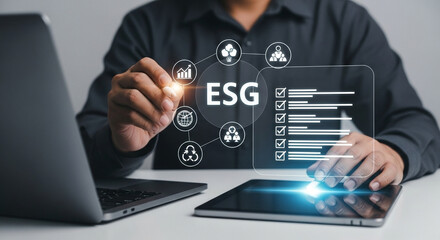 Poster - Person interacting with esg interface on tablet with laptop visible on the table next to it