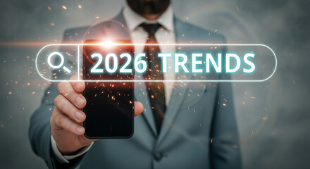 Poster - Man in suit holding phone with search bar overlay showing trends for the year twenty twenty six