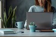 © Plastik - Female Employee Working on Laptop with Mug and Stationery on Portable Workspace