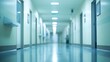 © masaidee - Blurred perspective of a long, empty hospital corridor with shiny blue floors and bright lighting, symbolizing a modern medical facility