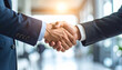 © HumblePride - Business Deal Handshake: Two businesspeople in suits shake hands, symbolizing a successful business deal or partnership.