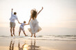 © Garun Studios - Family holiday vacation beach. Asian happy family outdoors summer travel. Fun families outdoors. Family vacation beach.