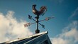 © Nazia - Traditional weather vane showing wind direction against blue sky background