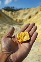 Aufkleber - Hand holds uranium in open mining site under bright sky Generative AI