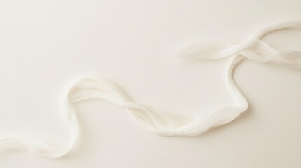 Poster - Delicate White Fabric Flowing Elegantly Against a Soft Cream Background Creating a Serene and Minimalist Aesthetic for Modern Design Projects