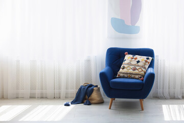 Aufkleber - Comfortable blue armchair with cushion near window indoors, space for text